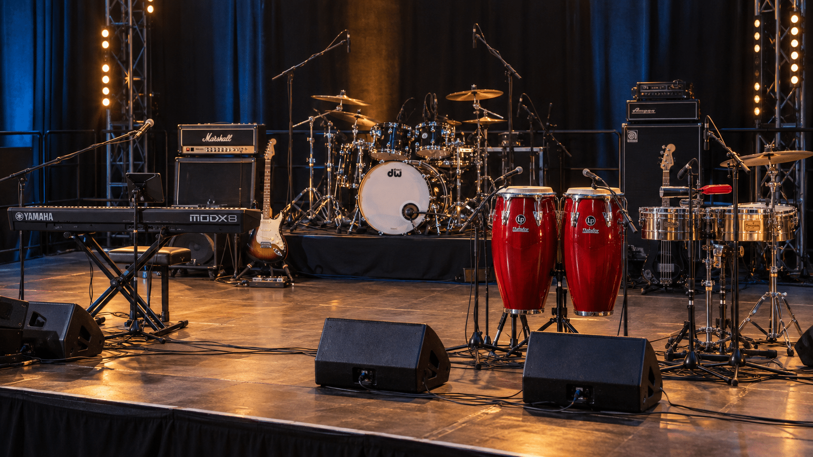 Backline profesional con batería, teclado Yamaha MODX8, congas LP Matador y timbal para eventos